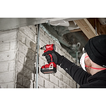 Worker using the Compact Brushless 1/4" Hex 3-Speed Impact Driver to drill a screw into concrete