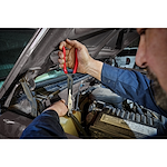 Worker using the long reach hose grip pliers underneath the hood of a car