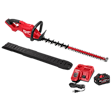 Image of the M18 FUEL™ 30" Hedge Trimmer Kit, which includes a red and black hedge trimmer, black protective blade cover, red battery charger, black power cord, and black battery.