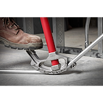 1/2" EMT Aluminum Conduit Bender with red handle being used by a person wearing a work boot to bend a metal conduit pipe.