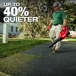 Person using a red leaf blower on a driveway with text "UP TO 40% QUIETER" in the upper left corner.
