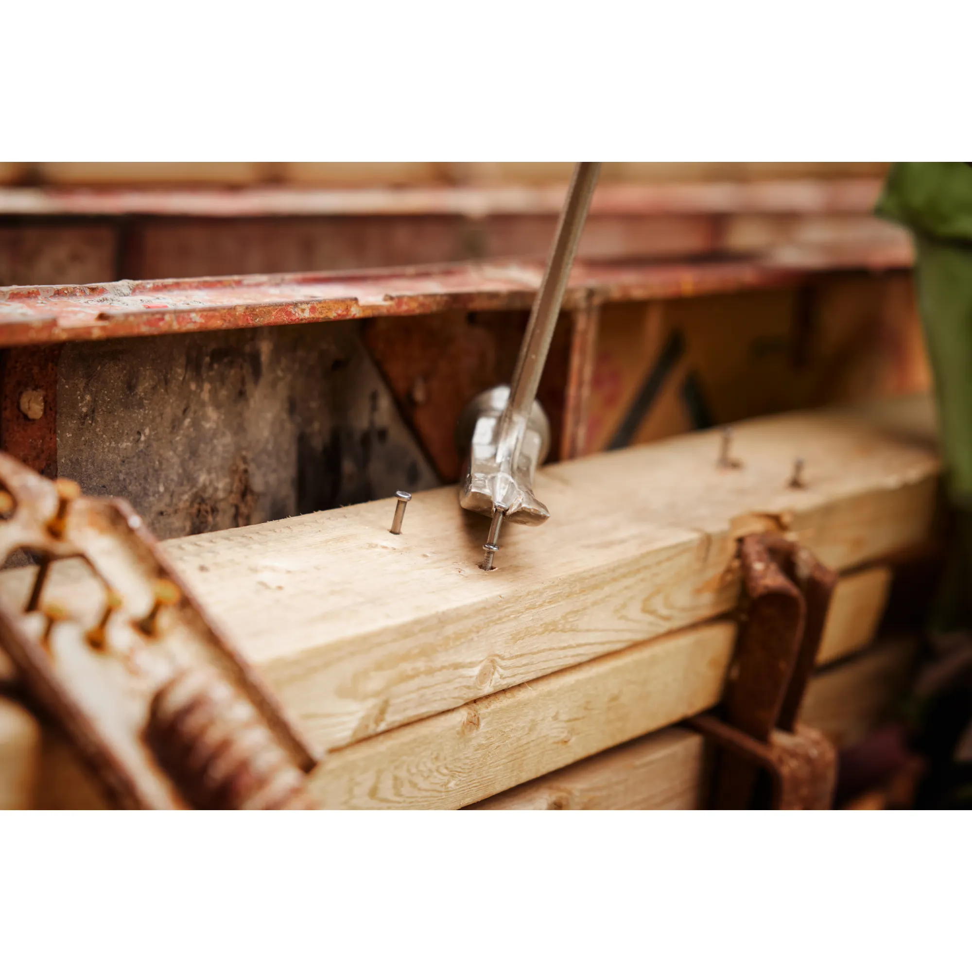 Close up image of the Milwaukee 8D 2-1/4” x .131” Collated Duplex Nails being used to nail wood together