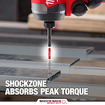The image shows a SHOCKWAVE™ SHOCKZONE™ Philips Bit being used with a power tool to drive a screw into metal. Text on the image highlights that the SHOCKZONE™ technology absorbs peak torque, enhancing durability. The product branding "SHOCKWAVE IMPACT DUTY™" is visible at the bottom.