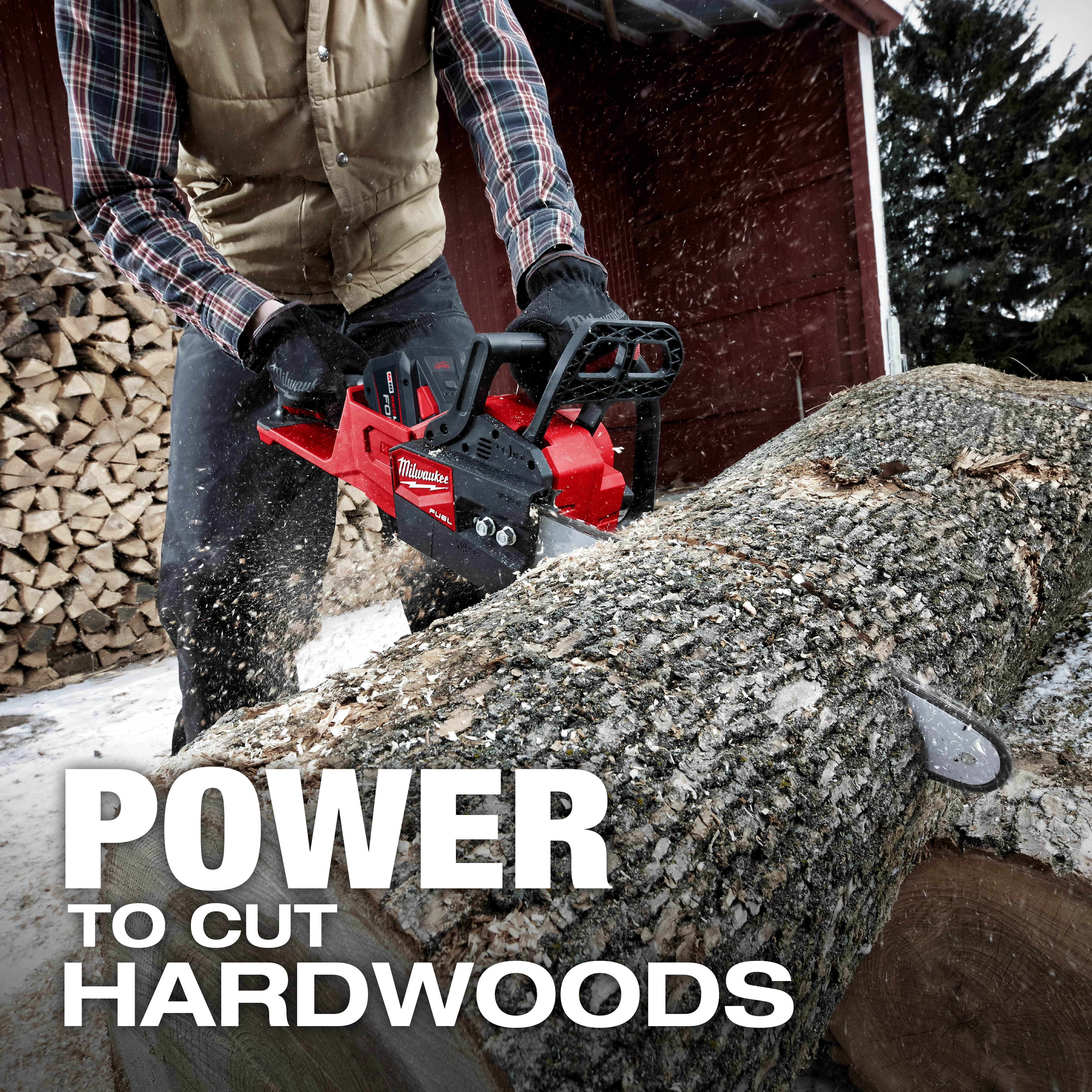 A person wearing gloves and a vest operates the M18 FUEL Chainsaw to cut a large log outdoors. Wood is stacked in the background. The text "POWER TO CUT HARDWOODS" is prominent in the foreground.