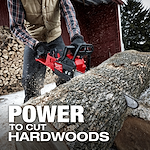 A person wearing gloves and a vest operates the M18 FUEL Chainsaw to cut a large log outdoors. Wood is stacked in the background. The text "POWER TO CUT HARDWOODS" is prominent in the foreground.